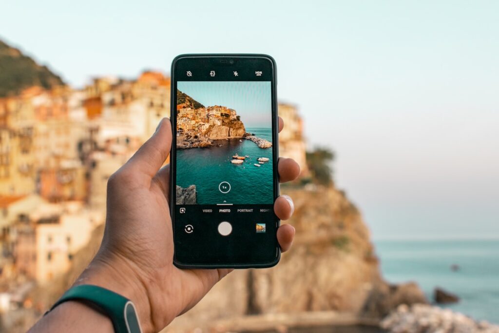 Smartphone showing travel apps on screen with map in background