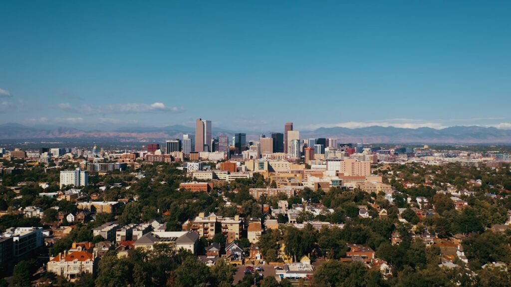 Denver on a budget: the Denver skyline with the Rocky Mountains rising behind downtown