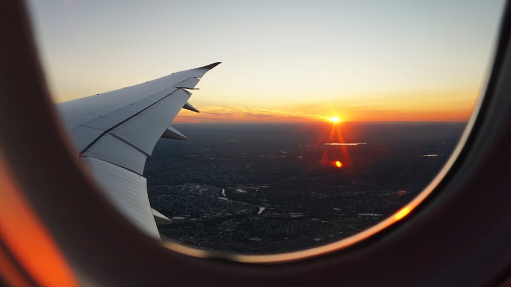 Airline miles pay for this seat — airplane window view of the sky at golden hour