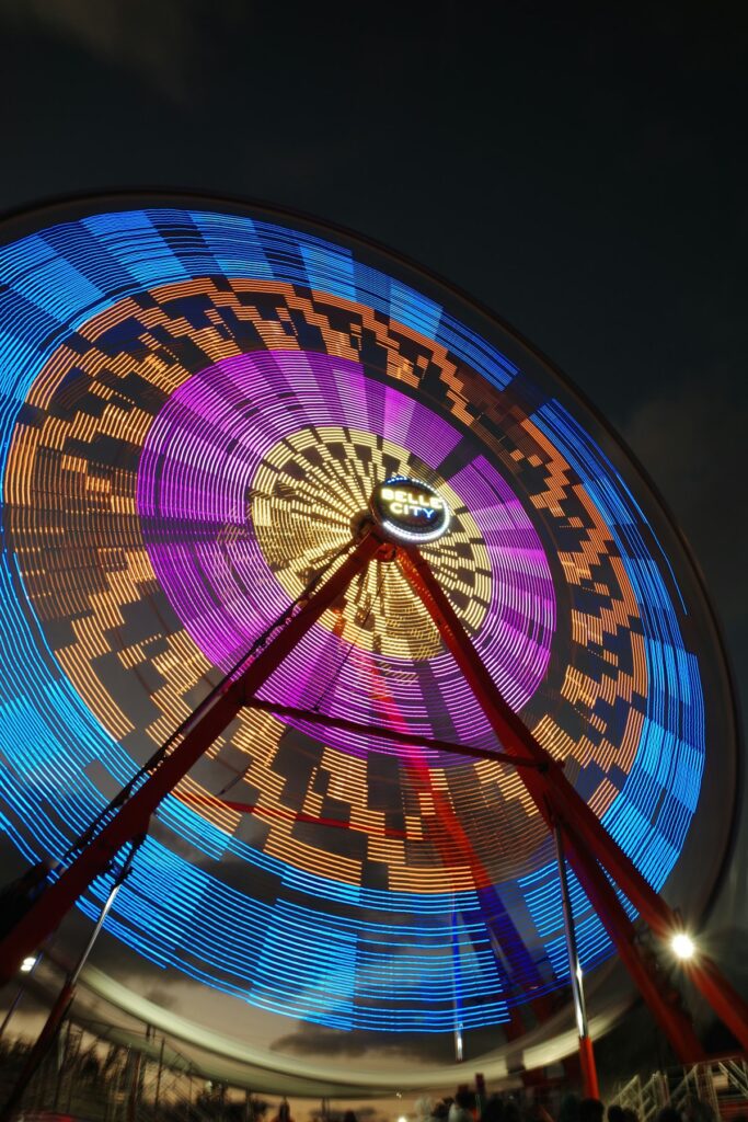 Best state fairs midway with a colorful ferris wheel lit up at night